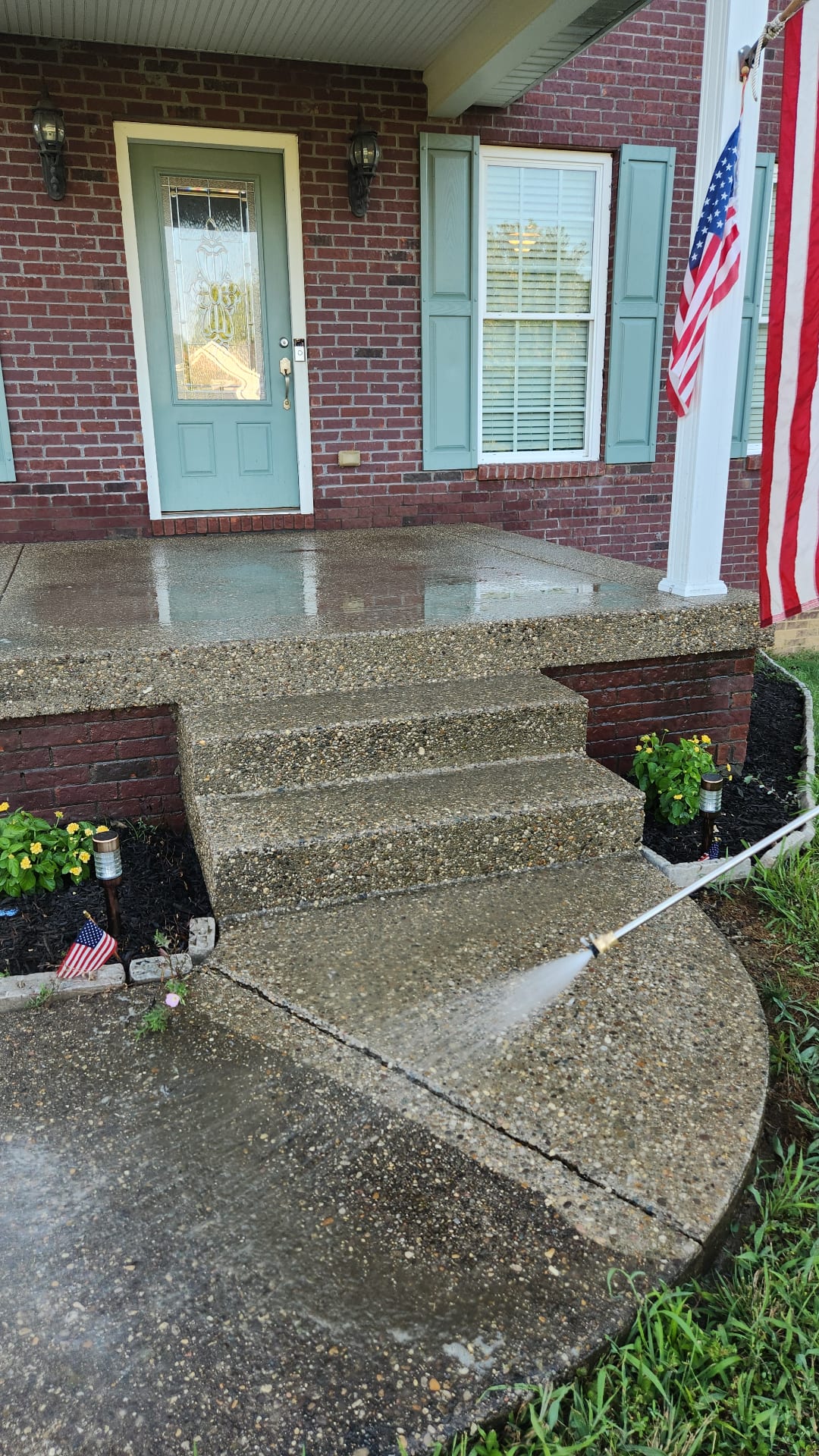 Freshly washed concrete porch and steps after pressure washing
